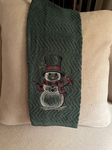 Snowman on green kitchen towel