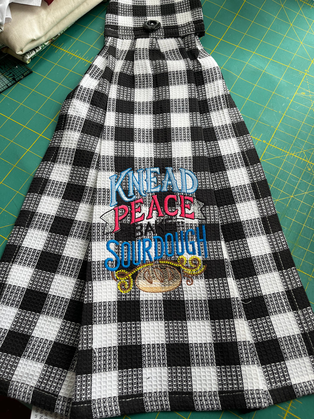 Over the door hanging towel.  Knead Peace, Bake Sourdough