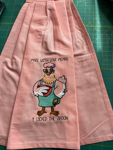 Over the door hanging towel.  "Made with Love means I licked the spoon"