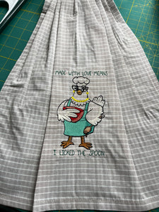 Over the door hanging towel.  "Made with Love means I licked the spoon"