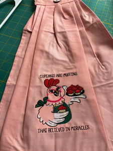 Over the door hanging towel.  "Cupcakes are muffins that believed in miracles"